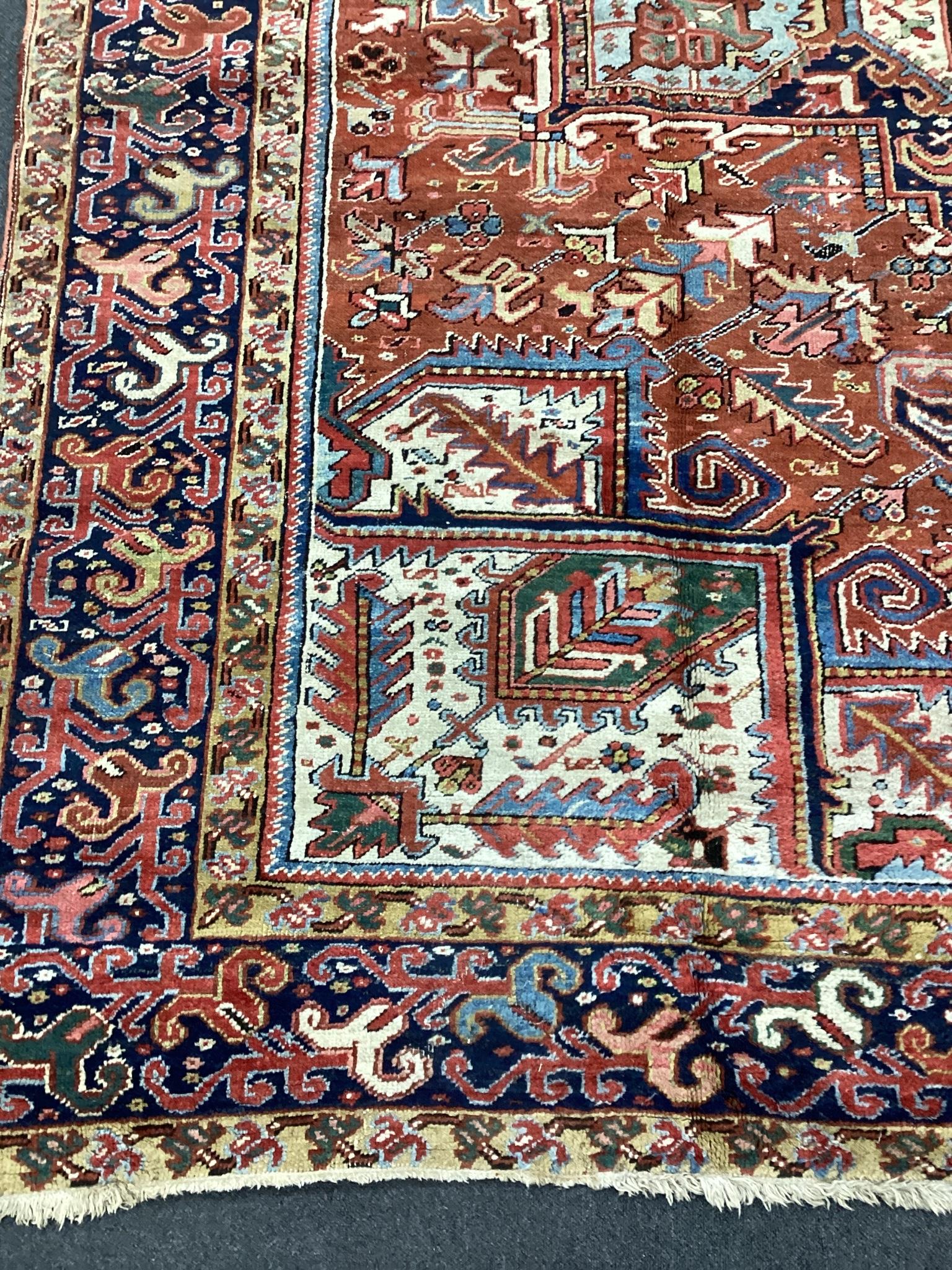 An early 20th century Heriz red ground carpet, 336 x 250cm